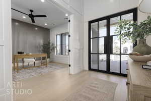 Office area featuring french doors, light wood-type flooring, and ceiling fan