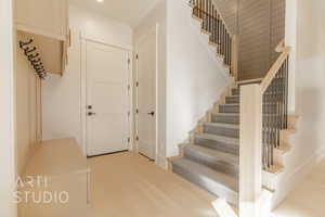 Stairway featuring hardwood / wood-style floors