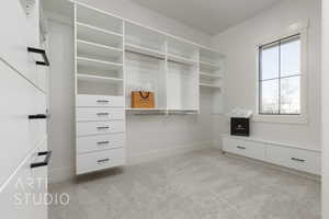 Spacious closet with light colored carpet