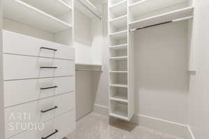 Walk in closet with light carpet