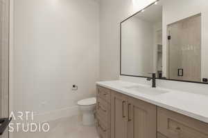 Bathroom with tile patterned flooring, vanity, toilet, and a shower with shower door