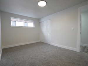 Unfurnished bedroom with carpet flooring and a closet