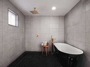 Bathroom featuring shower with separate bathtub and a textured ceiling