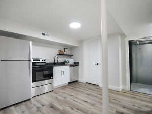 Mother-in-law Kitchen with white cabinetry