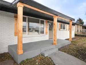 Entrance to property featuring a porch