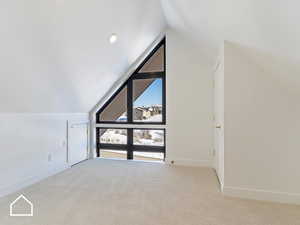 Bonus room with light carpet and lofted ceiling