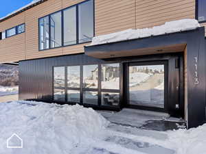 View of snow covered property entrance