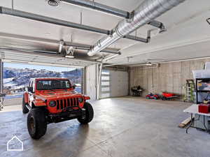 Garage with a mountain view and a garage door opener