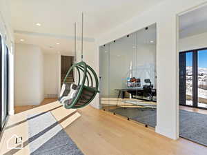 Workout room with a healthy amount of sunlight and wood-type flooring