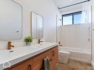 Full bathroom with vanity, toilet, and shower / tub combo with curtain