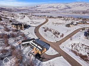 Snowy aerial view featuring a mountain view