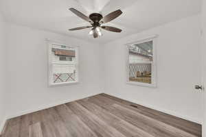 Empty room featuring ceiling fan and light wood-type flooring