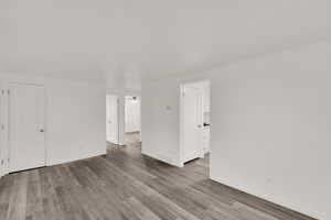 Spare room featuring hardwood / wood-style flooring, ceiling fan, and ornamental molding