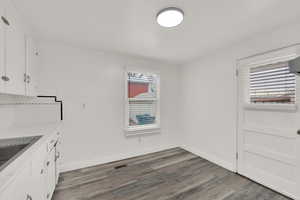 Unfurnished dining area with wood-type flooring and sink