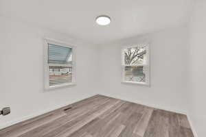 Spare room featuring light wood-type flooring