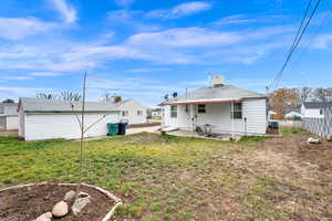 Back of property featuring a lawn, a patio area, and central AC unit