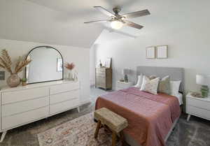 Carpeted bedroom featuring ceiling fan and lofted ceiling