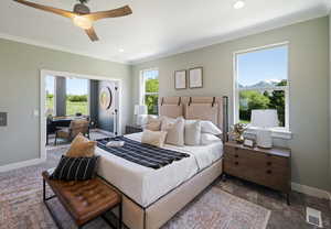 Carpeted bedroom featuring ceiling fan, a mountain view, and ornamental molding