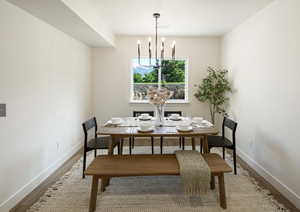 Dining area featuring hardwood / wood-style floors and a notable chandelier