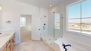 Full bath featuring a garden tub, double vanity, and a euro glass surround shower