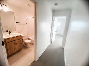 Full bathroom featuring bathing tub / shower combination, vanity, and toilet