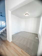 Unfurnished room featuring ceiling fan and wood-type flooring