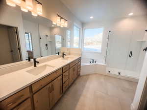 Bathroom with vanity, tile patterned floors, a mountain view, and independent shower and bath