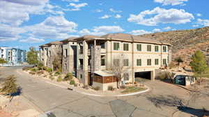 View of property with a mountain view and a garage