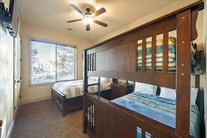 Carpeted bedroom with ceiling fan