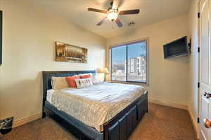 Carpeted bedroom with ceiling fan