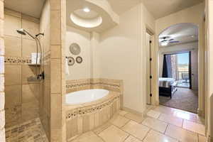 Bathroom with ceiling fan and independent shower and bath