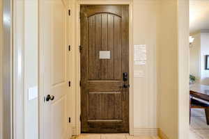 Interior space featuring light tile patterned floors and ornamental molding