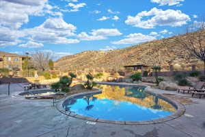 View of swimming pool with a mountain view and a patio