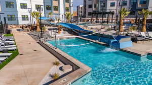 View of pool featuring a water slide and a patio