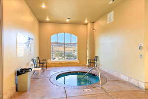 View of swimming pool with an indoor in ground hot tub