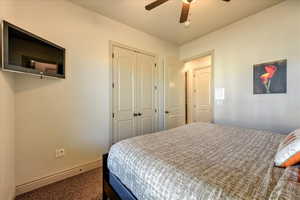 Bedroom featuring ceiling fan, carpet floors, and a baseboard radiator