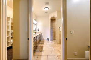 Bathroom featuring tile patterned flooring and vanity