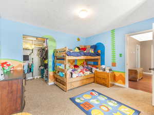 Bedroom #5 with a textured ceiling and a closet