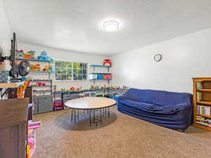 Bedroom #4 with carpet floors and a textured ceiling