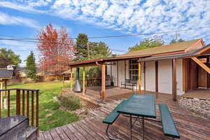 Wooden deck with a lawn and a grill