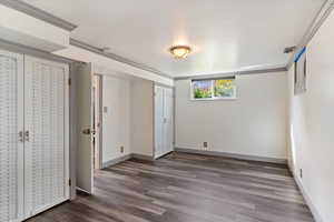 Unfurnished bedroom with crown molding and hardwood / wood-style floors