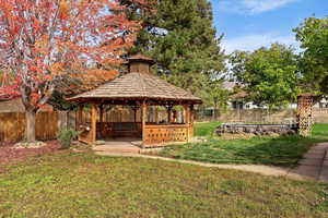 View of property's community featuring a gazebo and a yard