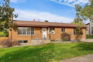 Ranch-style home with a front lawn