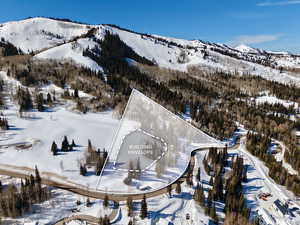 Snowy aerial view featuring a mountain view
