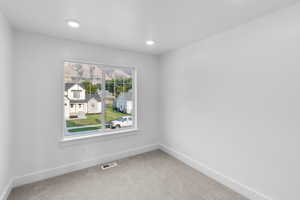 Carpeted empty room with plenty of natural light