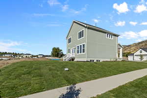 View of side of property featuring a yard