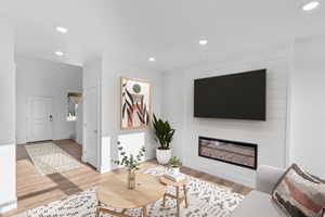 Living room featuring wood-type flooring and a fireplace