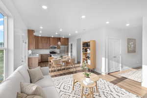 Living room with sink and light wood-type flooring