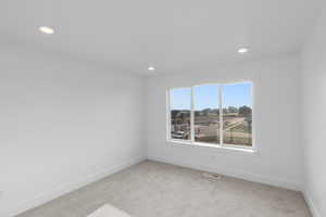 Unfurnished room featuring light colored carpet