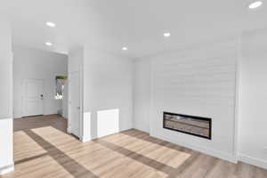 Unfurnished living room featuring a fireplace and hardwood / wood-style floors